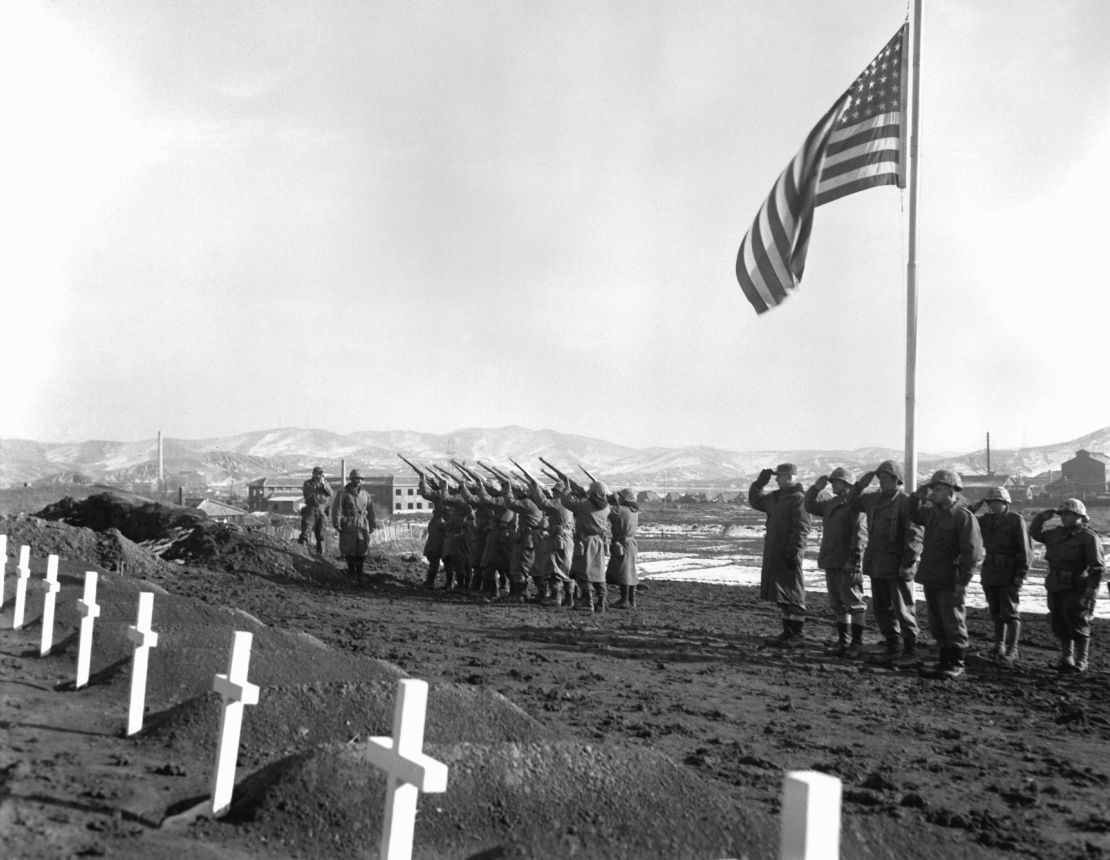 A Marine Corps honors brigade fires a volley over the graves of those who fell during the Battle of the Chosin Reservoir.