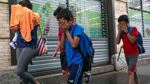 Groups of children being dropped off at Manhattan foster care agency, which Mayor Bill de Blasio says houses more than 200 migrant children. It's unclear whether the children in the photo, who cover their faces, are among those separated from their parents. 