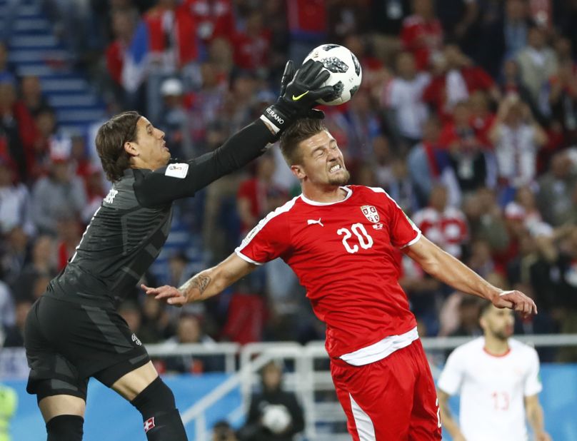 Swiss goalkeeper Yann Sommer catches the ball over Milinkovic-Savic.
