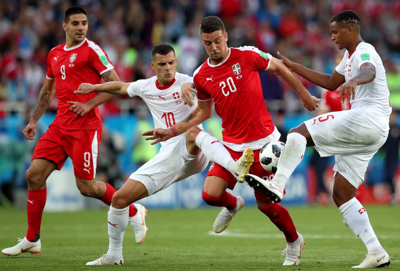 Swiss players defend Serbia's Sergej Milinkovic-Savic.