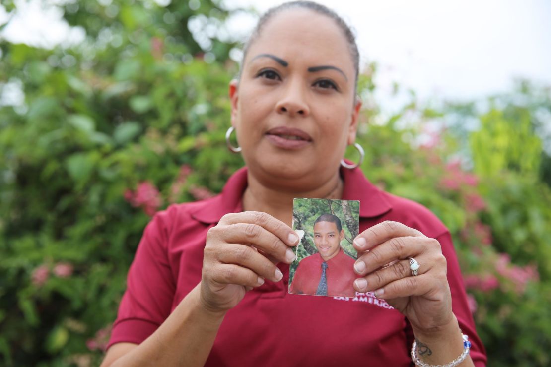 Daniel Vick's mother, Margarita Rodriguez, holds a photo of her son, whose death was labeled "leptospirosis" in a database obtained by CNN and CPI.