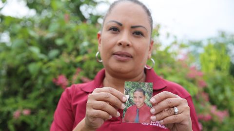 Daniel Vick's mother, Margarita Rodriguez, holds a photo of her son, whose death was labeled "leptospirosis" in a database obtained by CNN and CPI.
