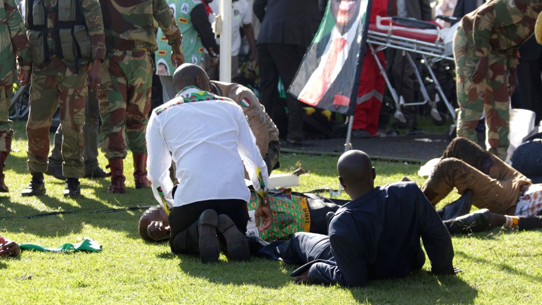 Injured people receive help after Saturday's blast in Bulawayo. CNN has blurred the faces of the injured.