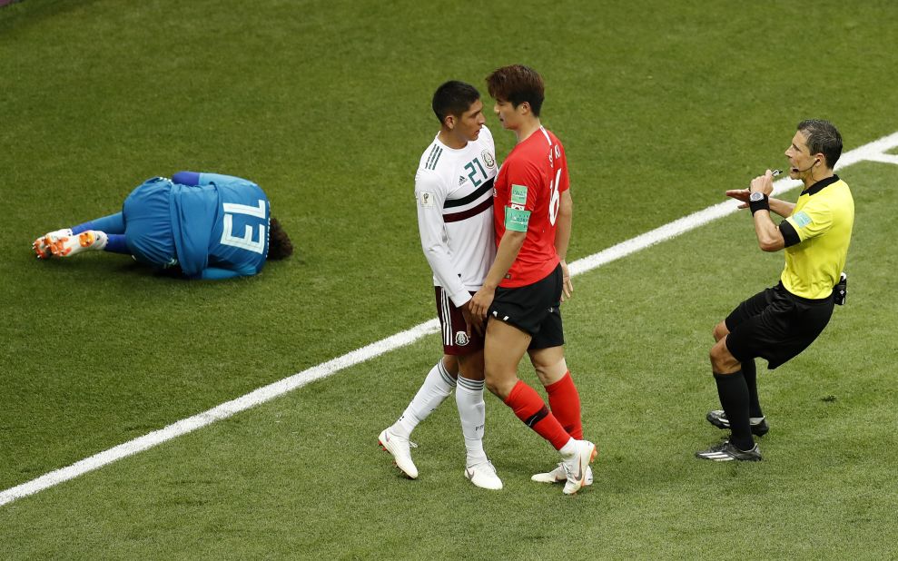 South Korea's Ki Sung-yueng, right, argues with Mexico's Edson Alvarez as Mexican goalkeeper Guillermo Ochoa lies on the ground on June 23. Mexico won 2-1.