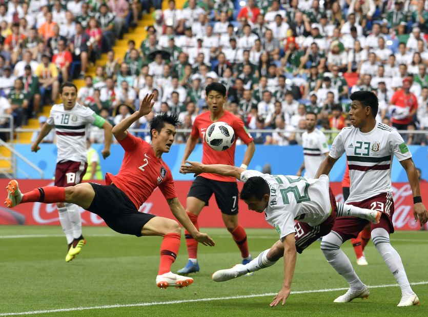 South Korea's Lee Yong, left, duels for the ball with Mexico's Hirving Lozano.