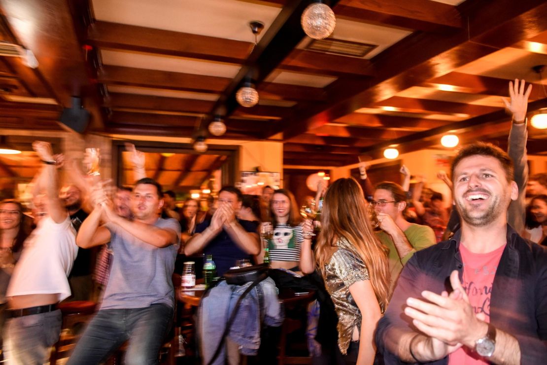 Kosovo Albanian supporters of Switzerland celebrate Xhaka's goal as they watch the match in a pub in Pristina.