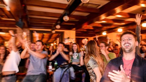 Kosovo Albanian supporters of Switzerland celebrate Xhaka's goal as they watch the match in a pub in Pristina.