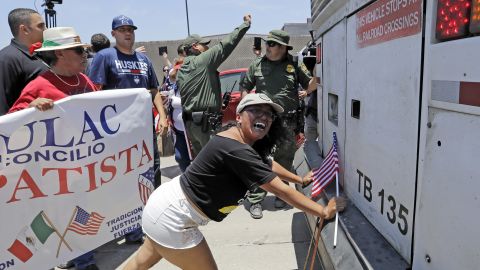 Demonstrator Martha Mercado tries to stop a bus with immigrant children onboard during a protest outside the U.S. Border Patrol Central Processing Center Saturday, June 23, 2018, in McAllen, Texas.