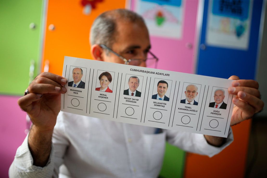 A polling station worker holds a ballot for Turkey's presidential election at a polling station in the mainly-Kurdish city of Diyarbakir, southeastern Turkey, on Sunday.