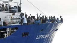 In this photo taken on Thursday, June 21, 2018, migrants wave from aboard ship operated by the German NGO Mission Lifeline. Italy's interior minister says Malta should allow a Dutch-flagged rescue ship carrying 224 migrants to make port there because the ship is now in Maltese waters. Salvini said the rescue was in Libyan waters, which Lifeline denies. (Hermine Poschmann/Mission Lifeline via AP)