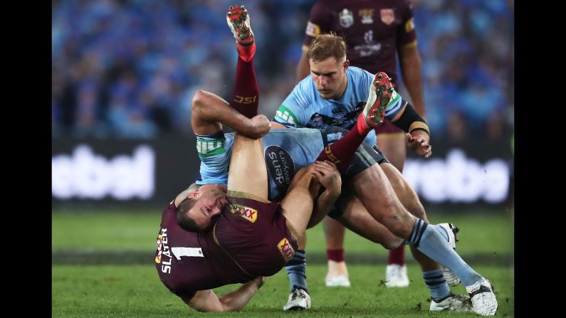 Billy Slater of the Queensland Maroons is tackled by Boyd Cordner of the New South Wales Blues during game two of the State of Origin rugby series on Sunday, June 24, in Sydney.  