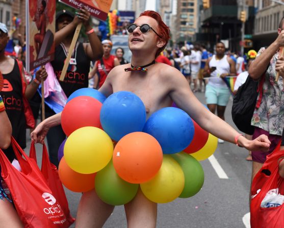 Balloons cover a reveler's body  at the New York march on Sunday.