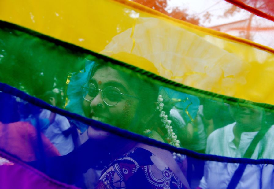 A supporter is seen through a rainbow flag at a Pride parade in Chennai, India, on Sunday.