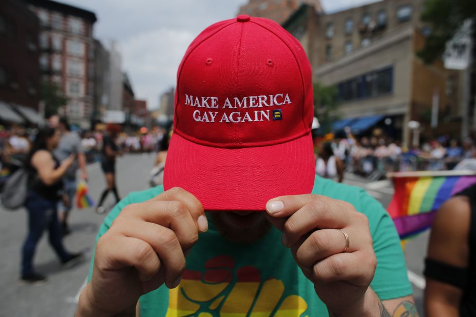 A reveler shows off his hat, which switches up President Trump's campaign slogan, at the New York march on Sunday. 