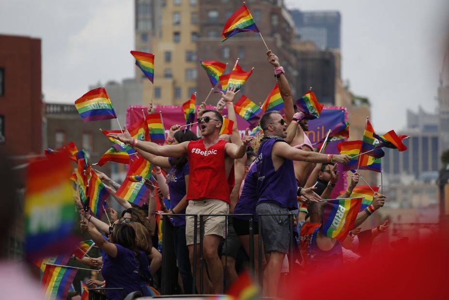 People wave flags on a float at the  New York City Pride March on Sunday.