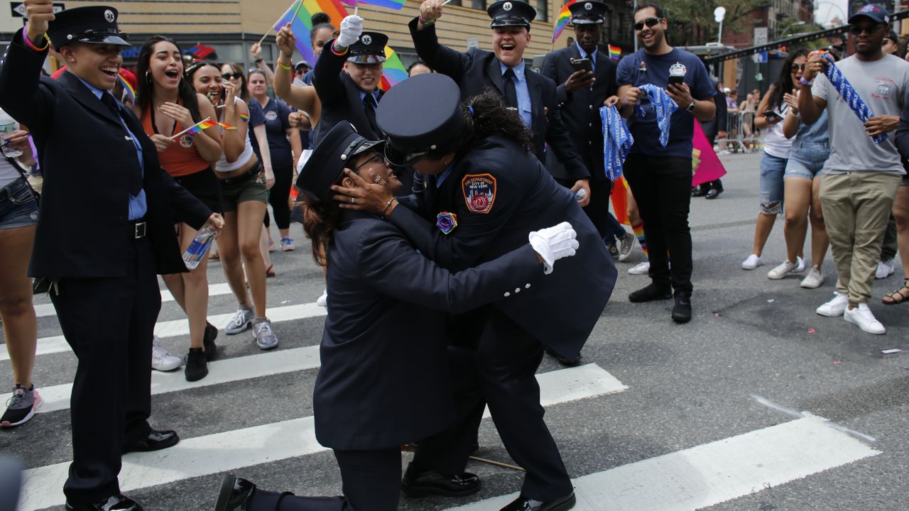  Members of the New York City Fire Department cheer as EMT Trudy Bermudez and paramedic Tayreen Bonilla get engaged at the annual Pride Parade 