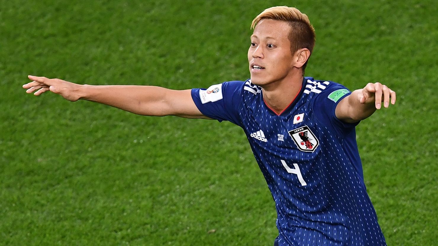 Japan midfielder Keisuke Honda celebrates after scoring against Senegal.
