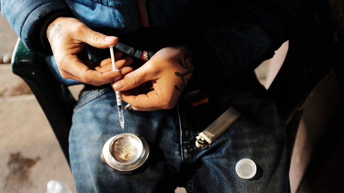 A man uses heroin under a bridge where he lives with other addicts in the Kensington section of Philadelphia which has become a hub for heroin use.