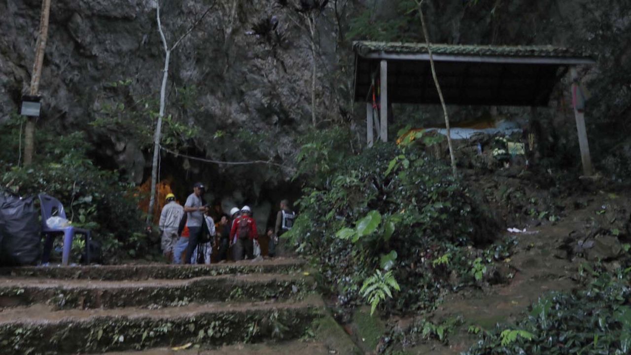 Rescue teams gather at the entrance of the deep cave where the team went missing.