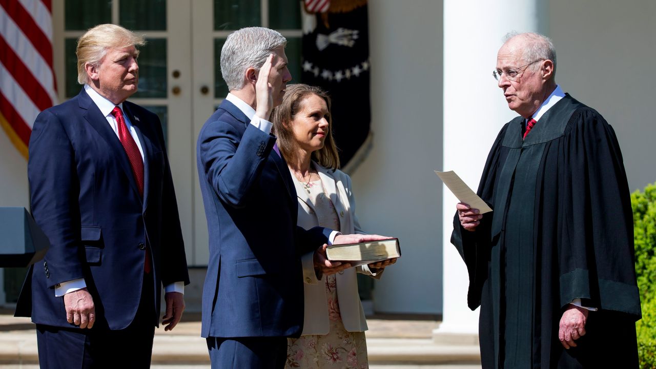 As President Trump looks on, Kennedy administers the judicial oath to new Justice Neil Gorsuch in April 2017.