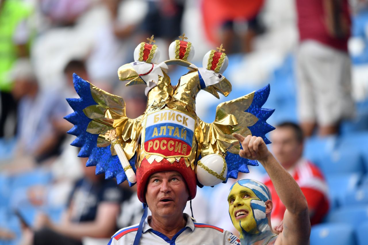 A Uruguay fan, right, poses with a Russia fan before the match.