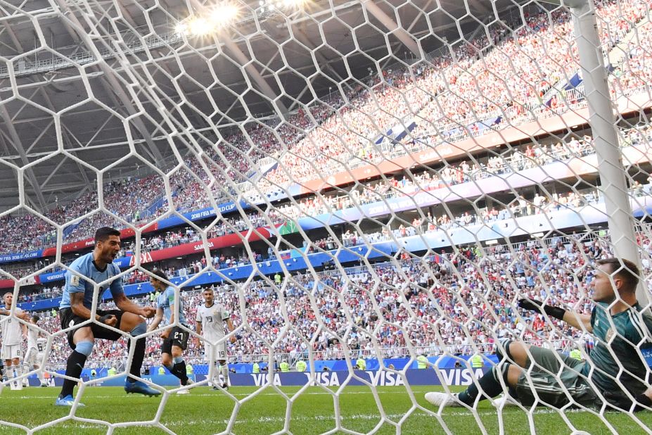 Uruguayan forward Luis Suarez, left, reacts after the second goal deflected past Russian goalkeeper Igor Akinfeev. 