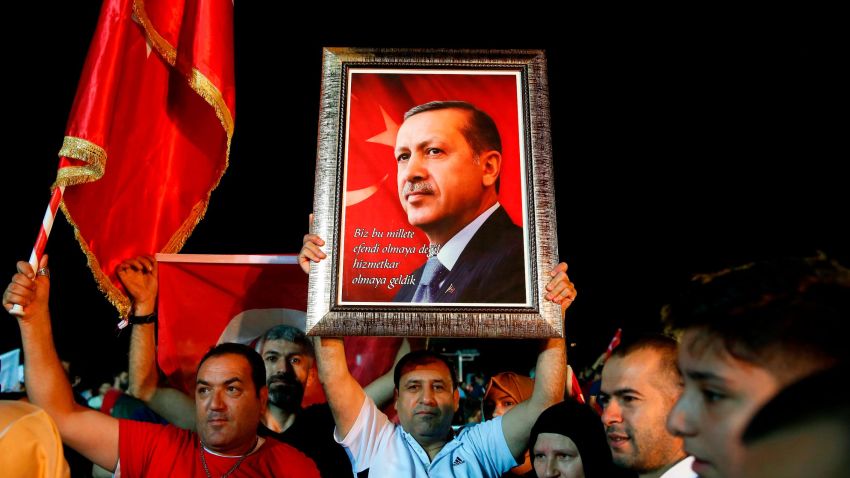 Supporters of Turkey's President Recep Tayyip Erdogan listen as he addresses them outside his official residence in Istanbul, Sunday, June 24, 2018. Erdogan has claimed victory in critical elections based on unofficial results, securing an executive presidency with sweeping powers. (AP Photo/Lefteris Pitarakis)