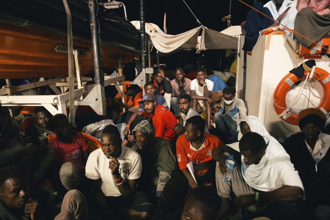 Rescued migrants sit in the search and rescue ship Lifeline earlier this week.