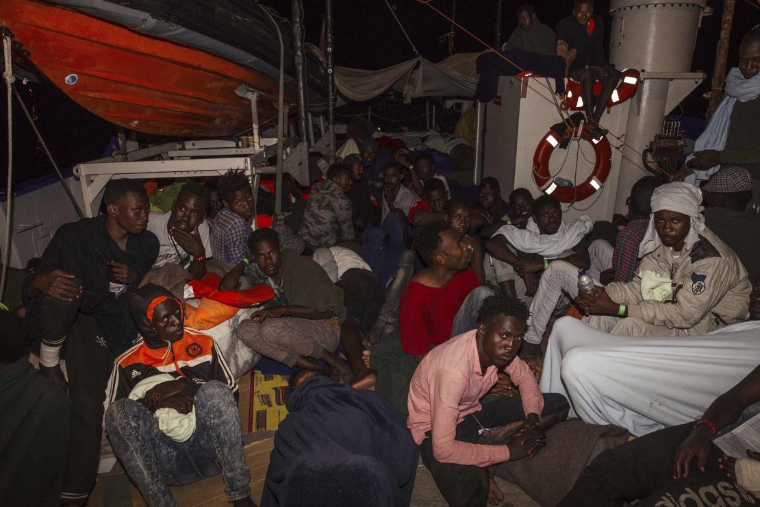 Migrants huddle on board the Lifeline in the early hours of Monday.