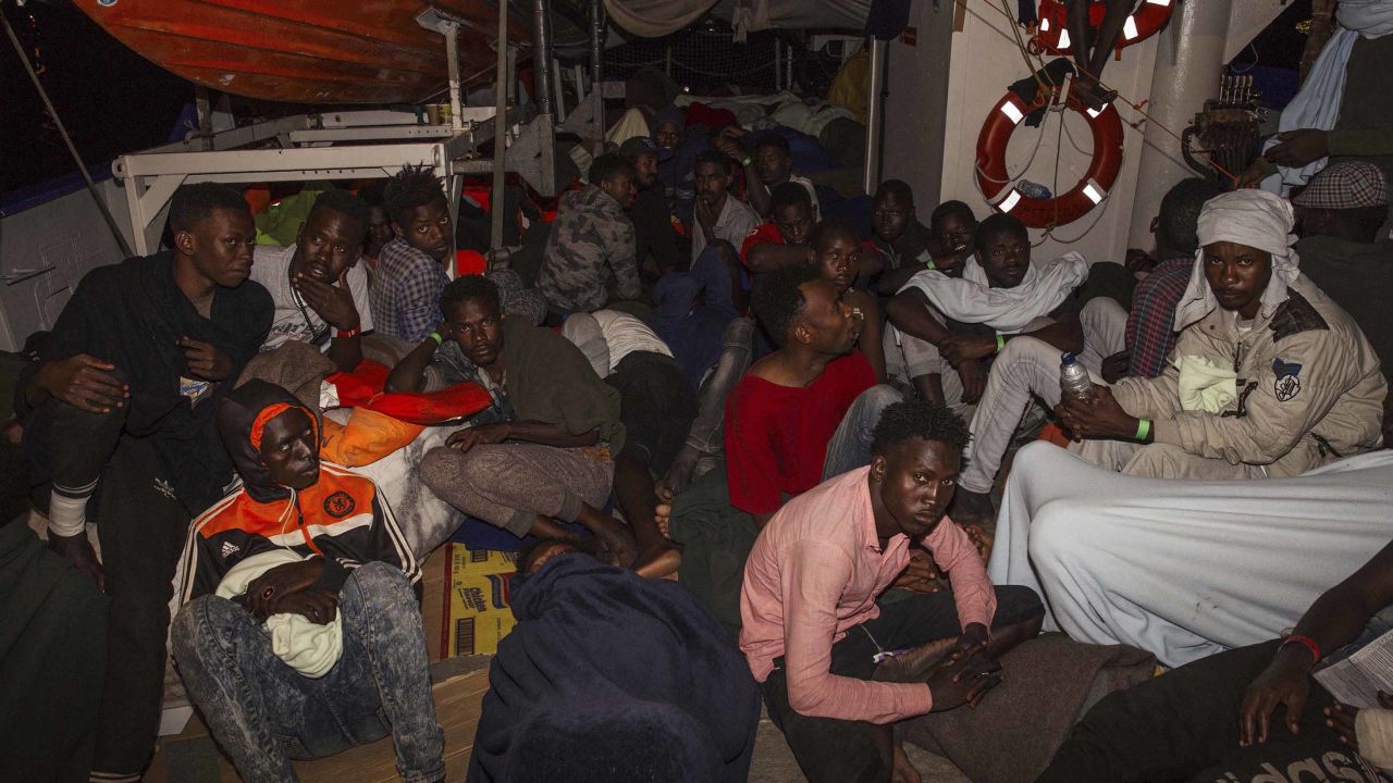 Migrants huddle on board the Lifeline in the early hours of Monday.