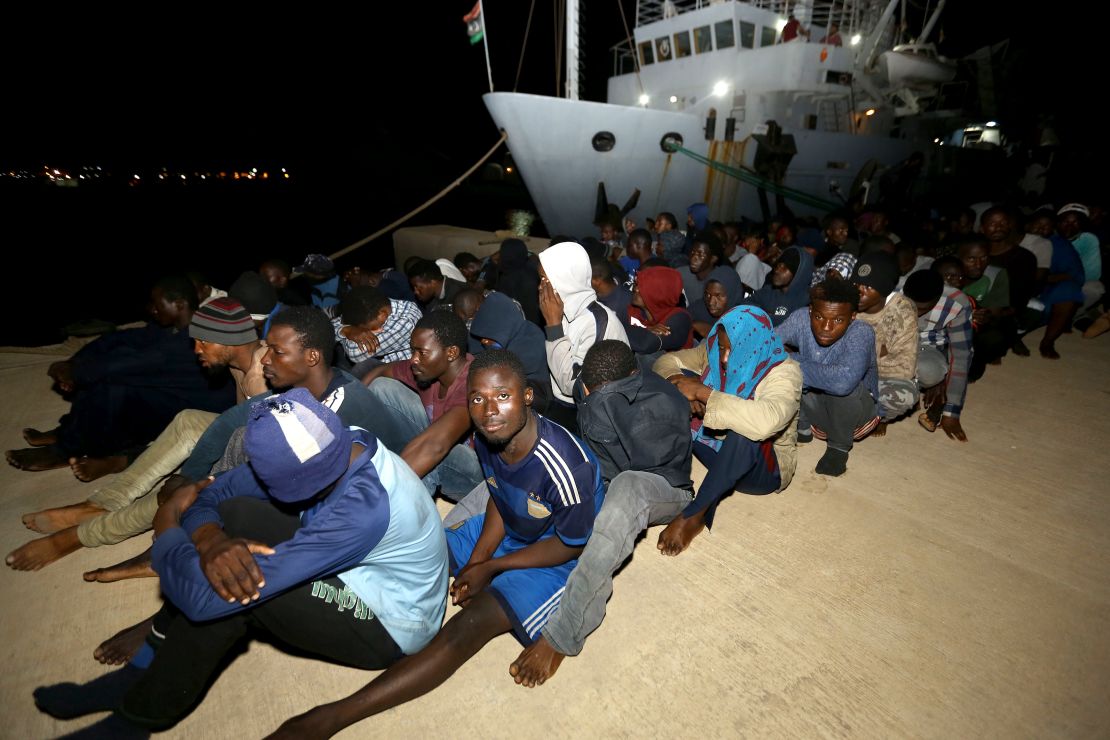 Migrants wait at a naval base in Tripoli, after being rescued in the Mediterranean on June 24, 2018. 
