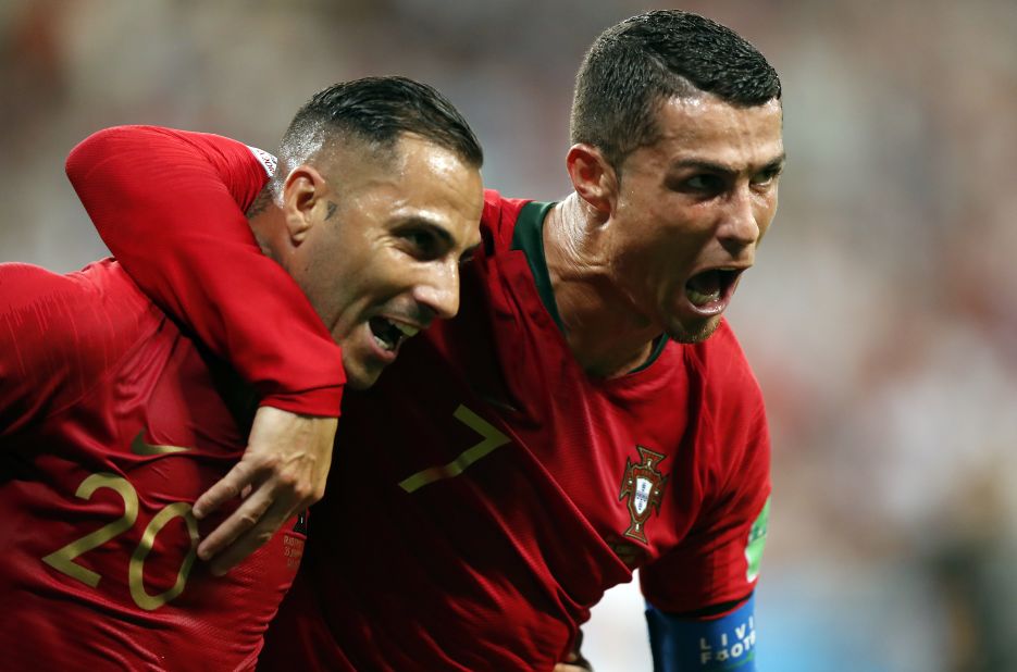 Portugal's Ricardo Quaresma, left, is embraced by Cristiano Ronaldo after scoring against Iran on June 25. Iran scored late to tie the match, but the 1-1 result was enough to see Portugal into the next round.