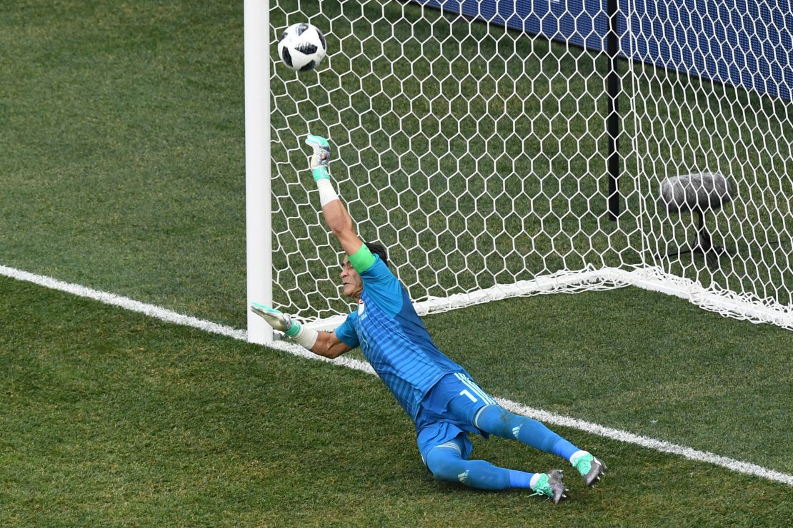 Egypt's goalkeeper Essam El Hadary dives to brilliantly save a penalty.