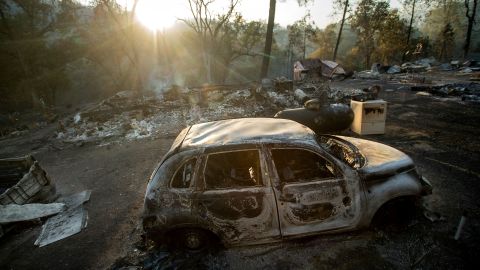 A vehicle scorched by a wildfire remains in a clearing on Wolf Creek Road near Clearlake Oaks.