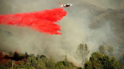 An air tanker drops retardant on a wildfire burning above the Spring Lakes community.