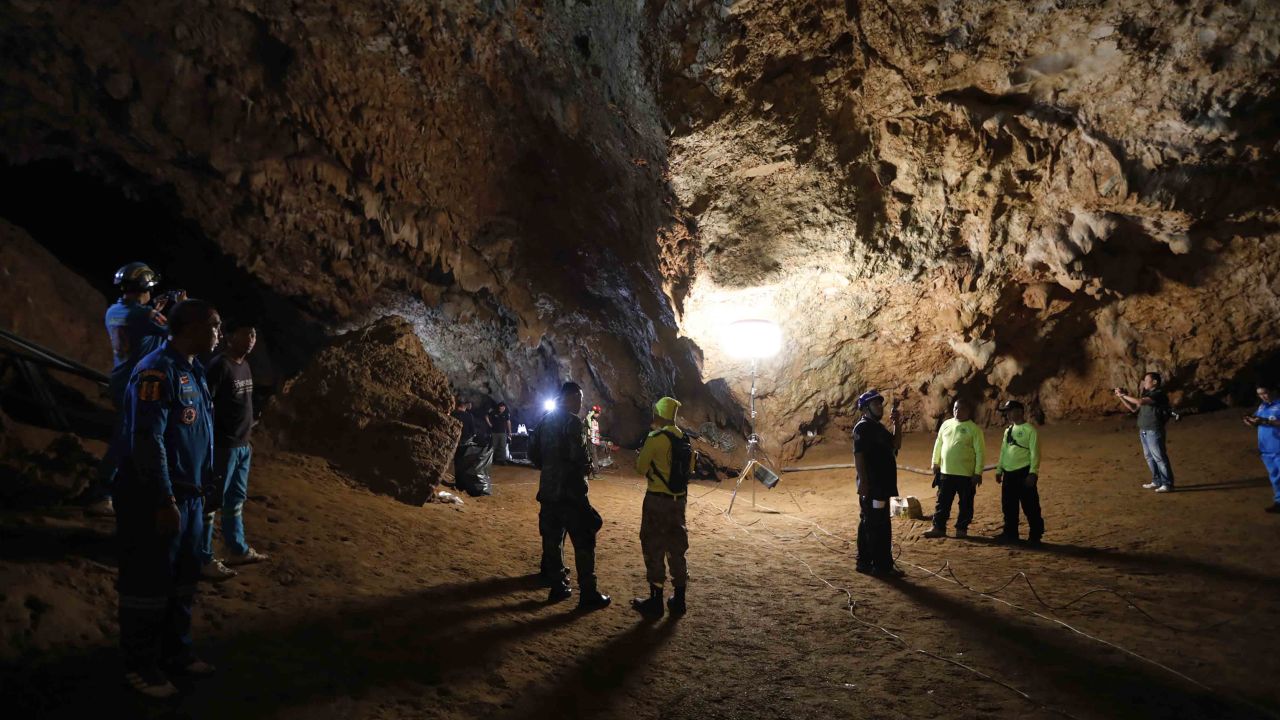 Rescue teams gather Monday in a deep cave where the group of boys went missing.