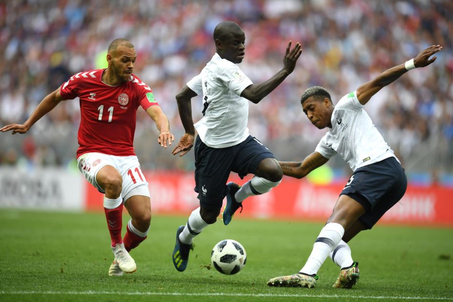 Denmark's Martin Braithwaite, left, is tracked by France's N'Golo Kante, center,  and Presnel Kimpembe.