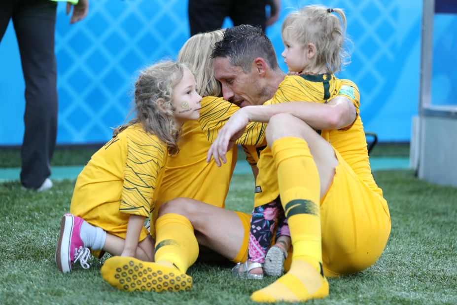 Australian player Mark Milligan is joined by his children after a 2-0 loss to Peru on June 26.