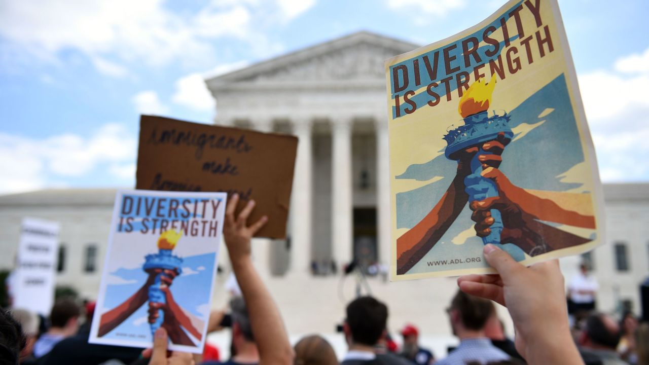 People protest the Muslim travel ban outside of the US Supreme Court in Washington, DC on June 26, 2018. - The US Supreme Court on Tuesday upheld President Donald Trump's controversial ban on travelers from five mostly Muslim countries -- a major victory for the Republican leader after a tortuous legal battle. In a majority opinion written by Chief Justice John Roberts, the court ruled 5-4 that the most recent version of the ban, which the administration claims is justified by national security concerns, was valid. (Photo by MANDEL NGAN / AFP)        (Photo credit should read MANDEL NGAN/AFP/Getty Images)