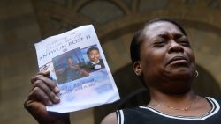 Carmen Ashley, the great aunt of Antwon Rose II, cries as she holds the memorial card from Rose's funeral during a protest calling for justice for the 17-year-old on June 26, 2018 in downtown Pittsburgh, Pennsylvania. Rose was killed by an East Pittsburgh police officer June 19 when he fled on foot from a traffic stop and was shot three times in the back. Days of protest and unrest have continued in the wake of his death. Justin Merriman/Getty Images
