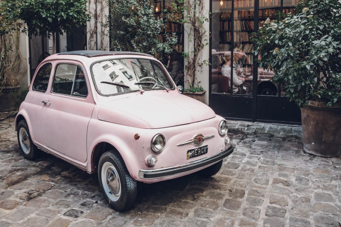 A classic Fiat 500 convertible -- commonly known as the Cinquecento in Italy -- sits in an alleyway in Paris, France. The model began production in Turin, Italy in 1957 and was discontinued in 1975. A modern version with a petrol engine was unveiled in Europe in 2007 and the US two years later. 