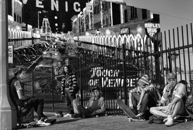 A group of young skateboarders in front of the "Touch of Venice" mural on Windward Avenue.