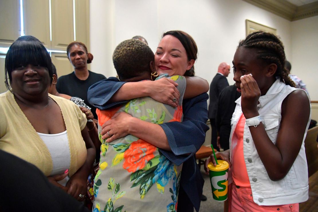 Broder, center, celebrates the Gebhardt verdict with Coggins' family and friends in June.