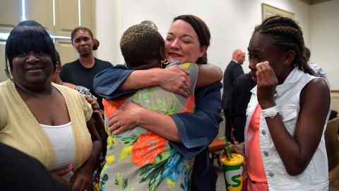 Broder, center, celebrates the Gebhardt verdict with Coggins' family and friends in June.