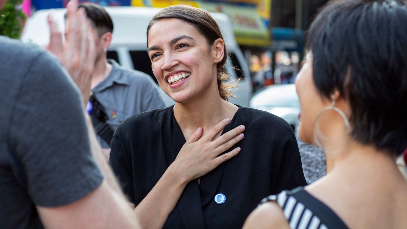 Ocasio-Cortez, seen here in a photo provided by her campaign, speaks with constituents.