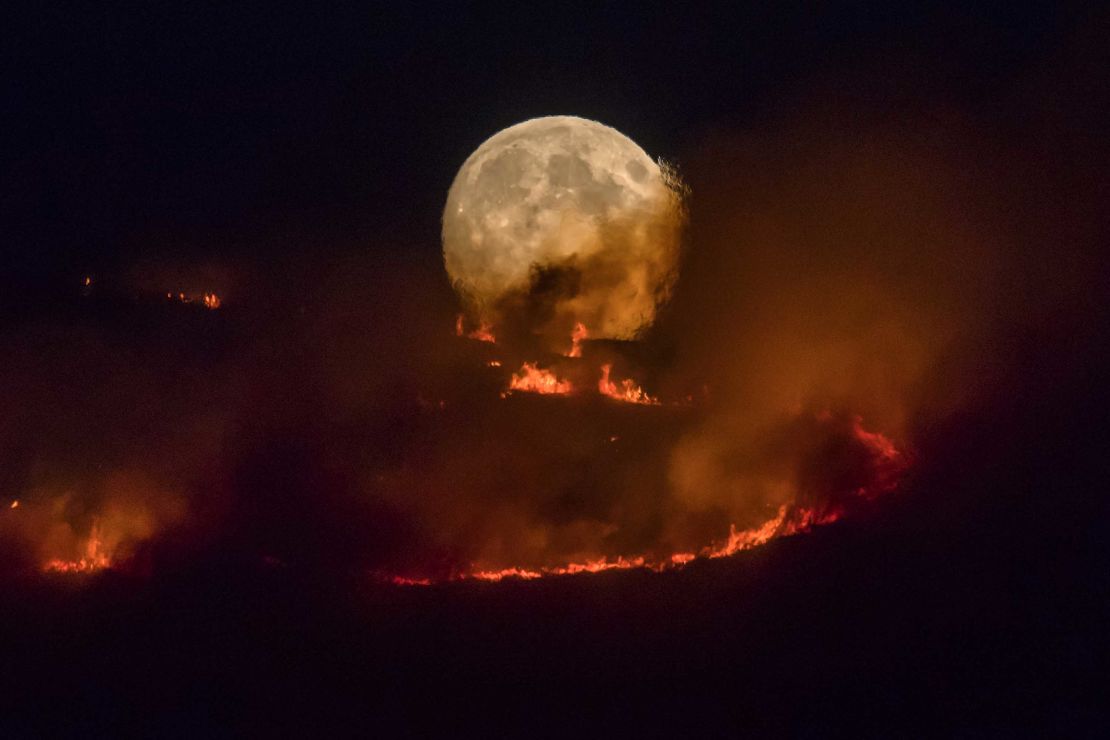 A large wildfire sweeps across moorland in northern England on June 26.