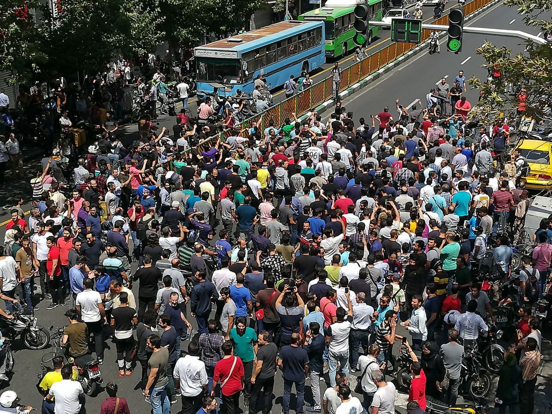 Iranian protesters shout slogans during a demonstration in central Tehran on Monday.