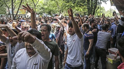 A group of protesters chant slogans at the Grand Bazaar in Tehran on Monday.