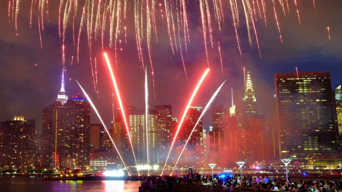 The Empire State Building (left) and the Chrysler Building can be seen in the background during the Macy's 2017 fireworks show from Queens.