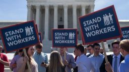 WASHINGTON, DC - JUNE 25: Demonstrators hold signs in front of the U.S. Supreme Court on June 25, 2018 in Washington, DC. The high court is expected to issue decisions in six remaining cases, including the travel ban, public sector unions and redistricting, ahead of their end-of-June deadline this week.  (Photo by Zach Gibson/Getty Images)